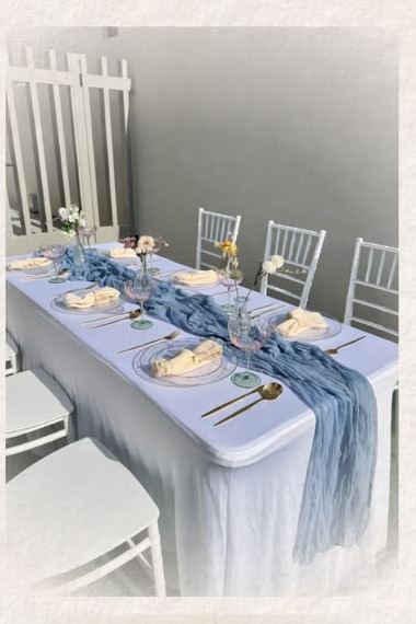 Long table with a blue runner and white Chiavari chairs